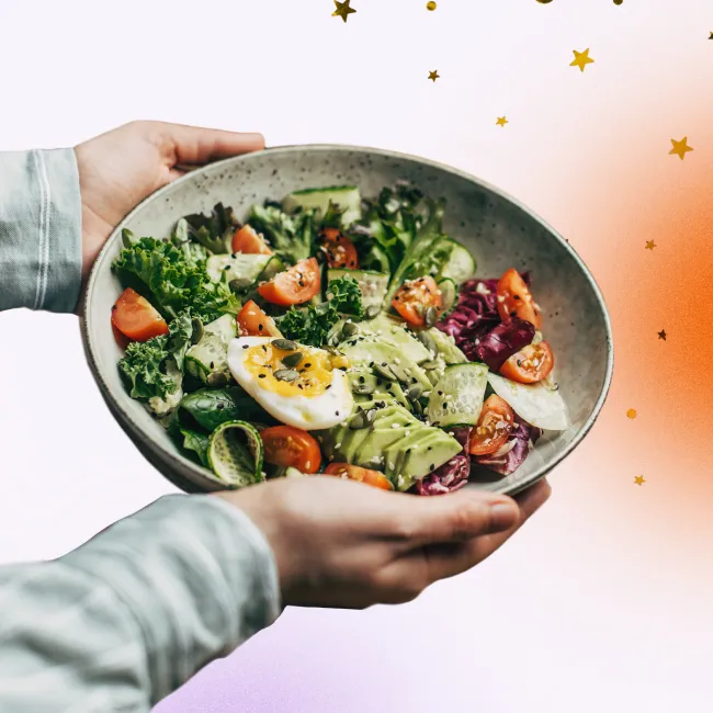 photo of hands holding a superfood salad 