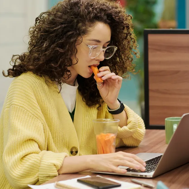photo of woman eating carrots