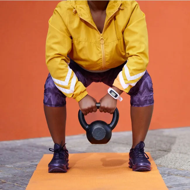 photo of woman training with weights in gym