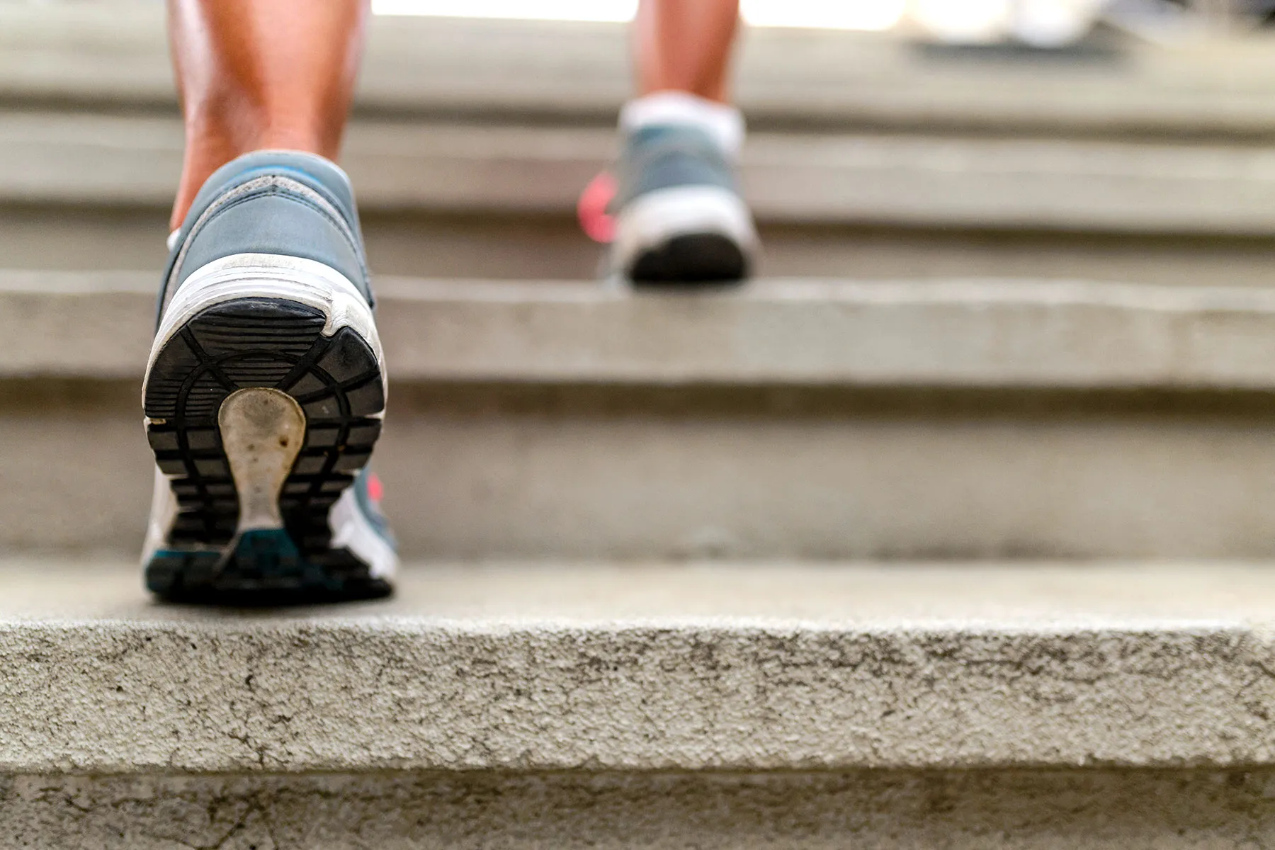 photo of feet walking up stairs