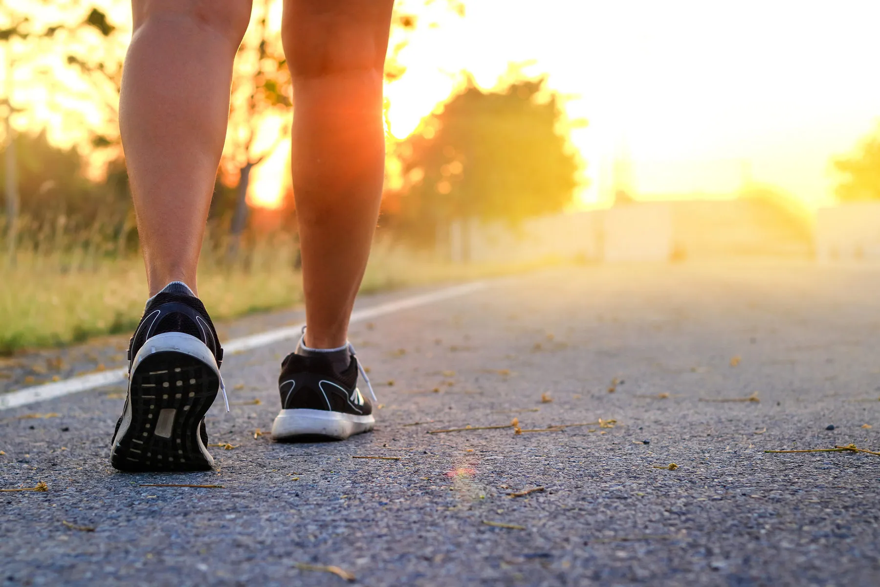 photo of feet walking on a gravel road