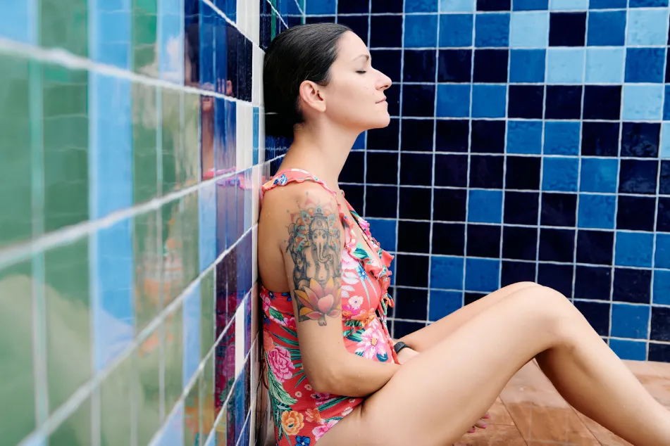 photo of adult woman in a swimsuit relaxing