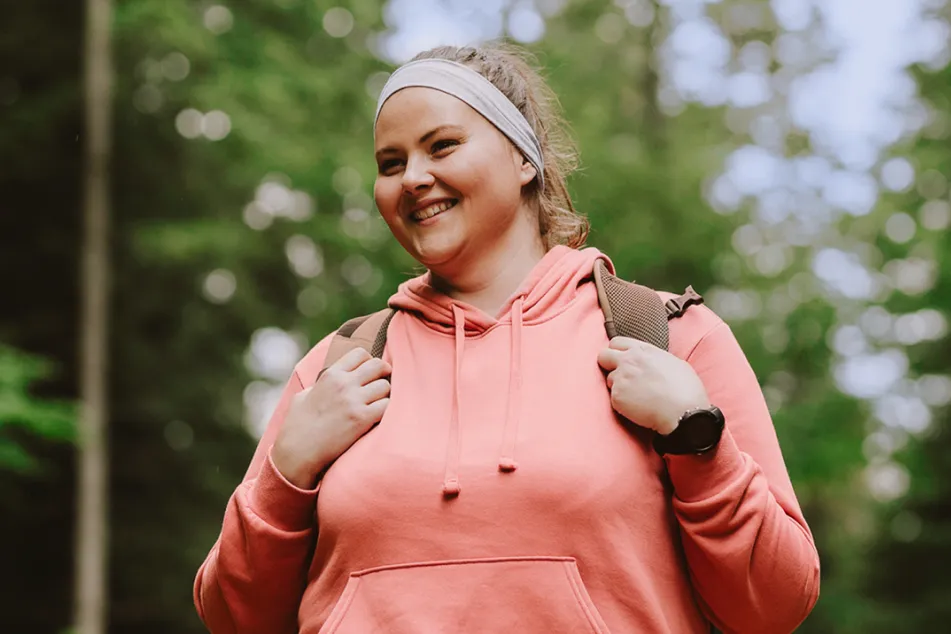 photo of a young woman hiking and feeling happy