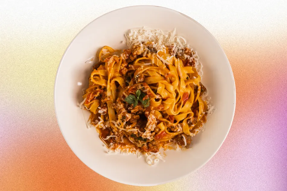 photo of pasta bolognese fettuccine with parmesan and meat sauce