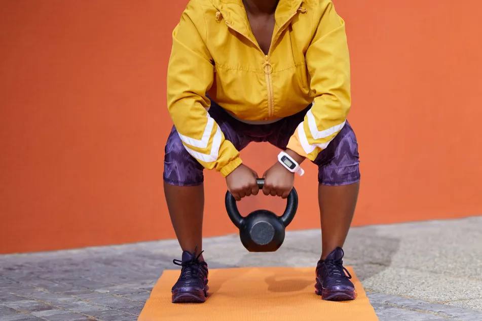 photo of woman training with weights in gym