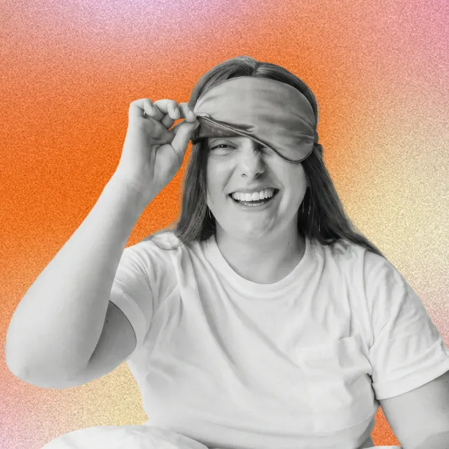 photo of a happy woman waking up and peeking under a sleep mask