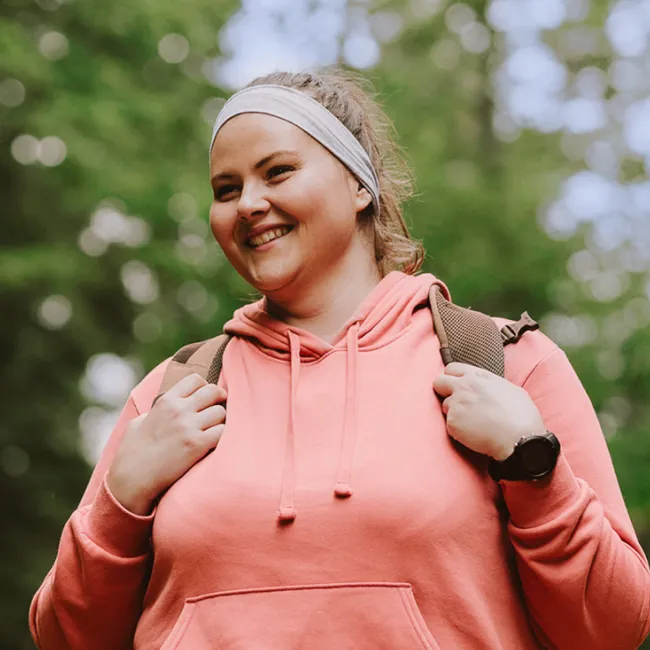 photo of young woman hiking outside