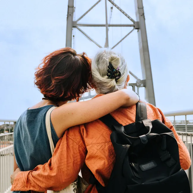 photo of a woman and her mother standing arm in arm