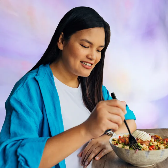 photo of a beautiful Asian woman seated enjoying her meal