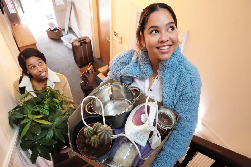 photo of two women moving into an apartment