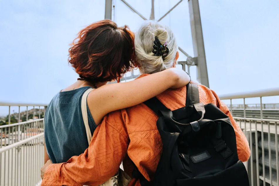 photo of a woman and her mother standing arm in arm