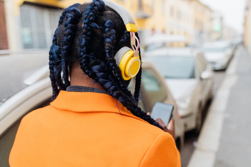 photo of woman with braided hair and headphones