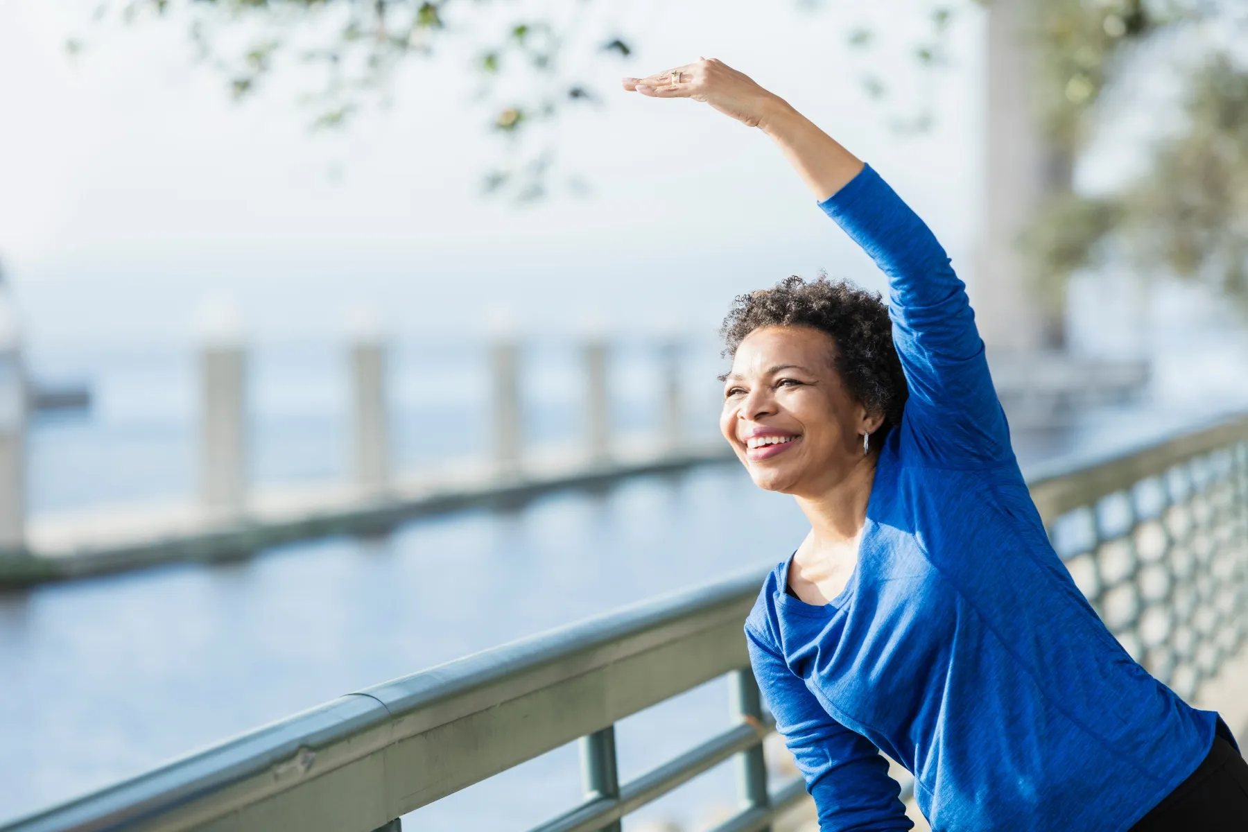 photo of a mature African-American woman exercising on waterfront