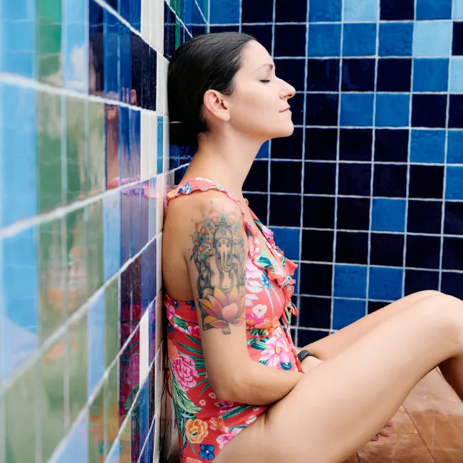 photo of adult woman in a swimsuit relaxing