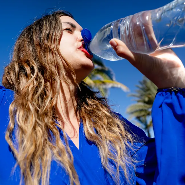 photo of woman drinking refreshing cold water