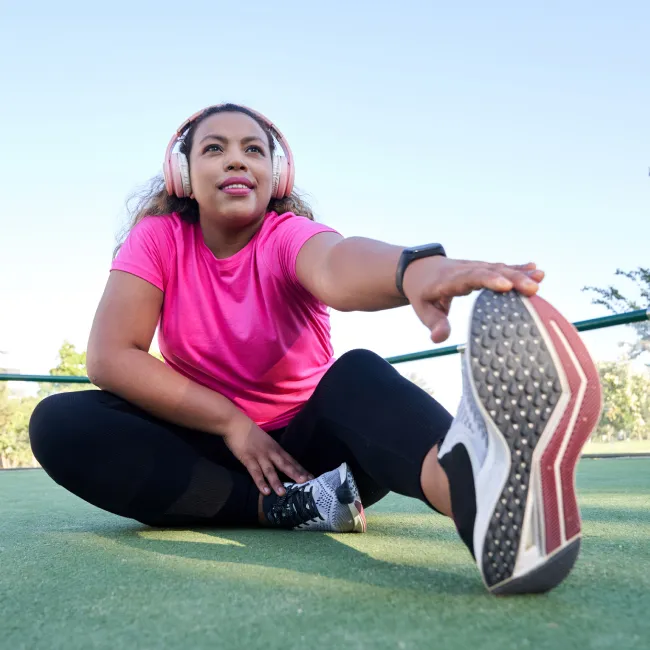photo of woman with large build stretching after jogging
