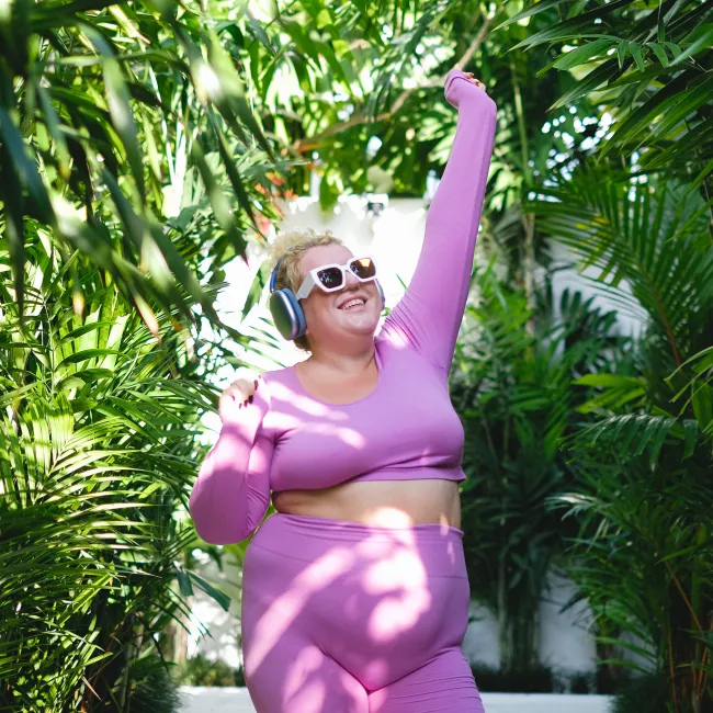 photo of overweight woman dancing outdoors