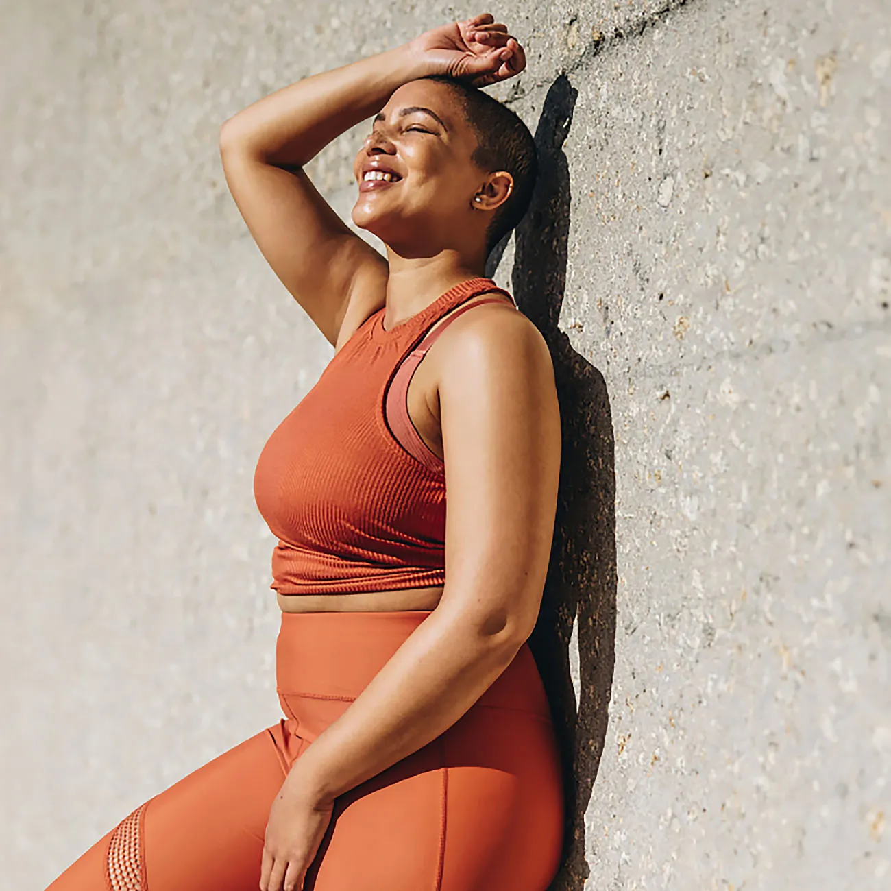 photo of woman leaning against wall