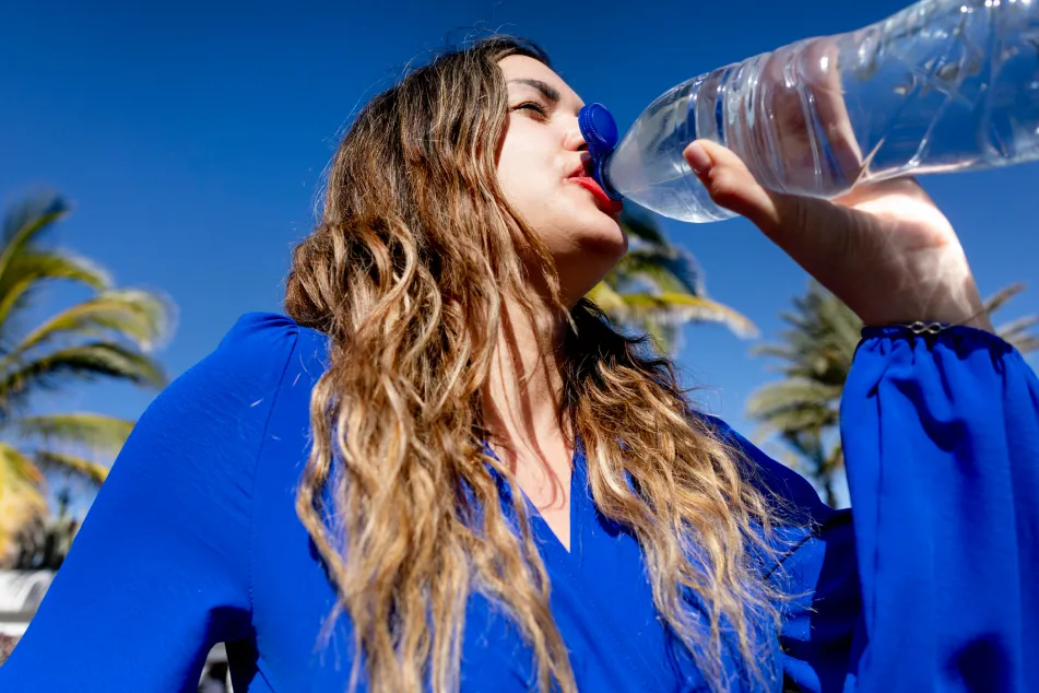 photo of woman drinking refreshing cold water