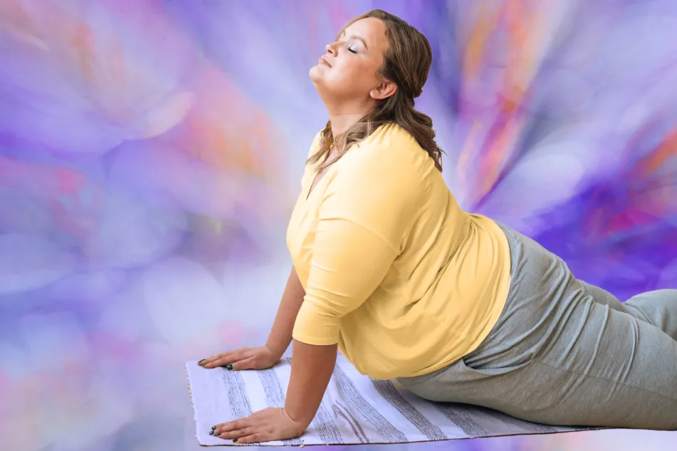 photo of plus size woman doing yoga over lilac background