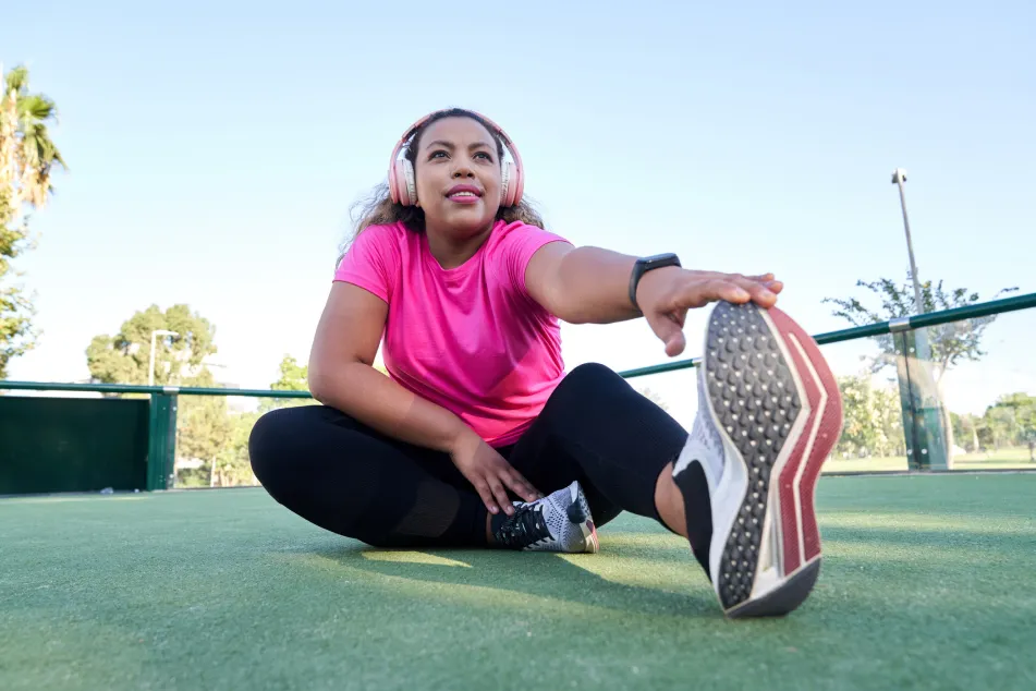 photo of woman with large build stretching after jogging