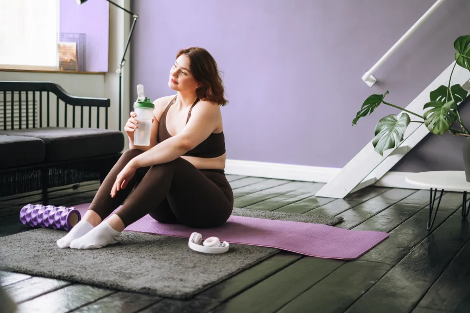 photo of plus size woman exercising at home