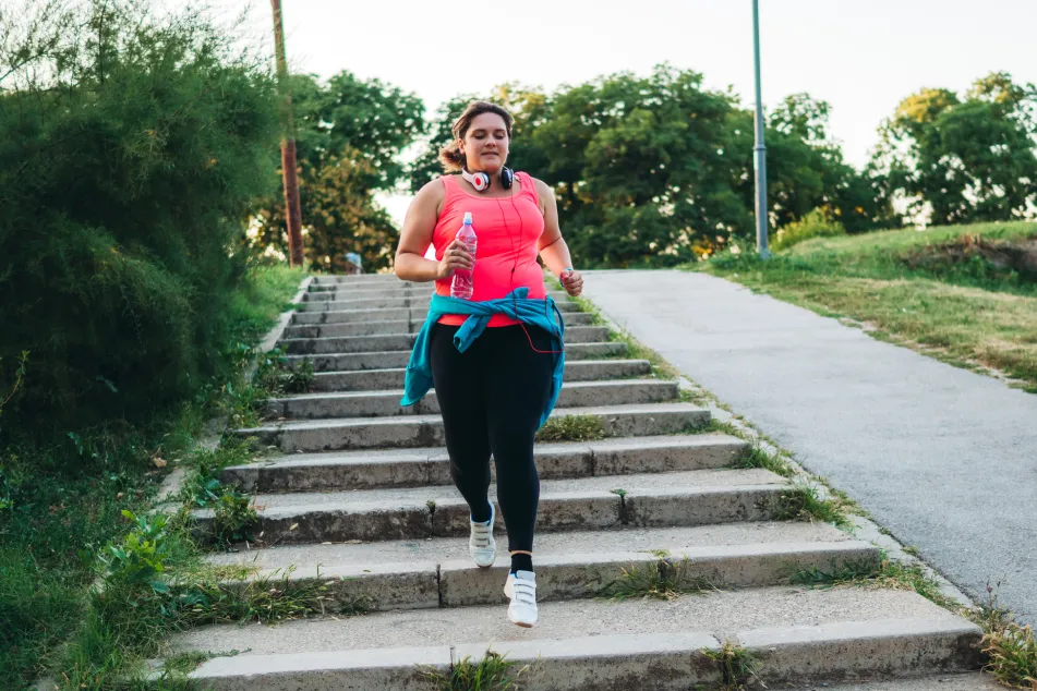 photo of woman running in a public park