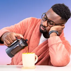 photo of man pouring coffee into a mug
