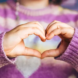 photo of heart and hands of woman for care