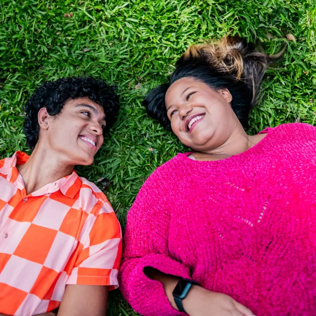 photo of Friends talking lying on grass 