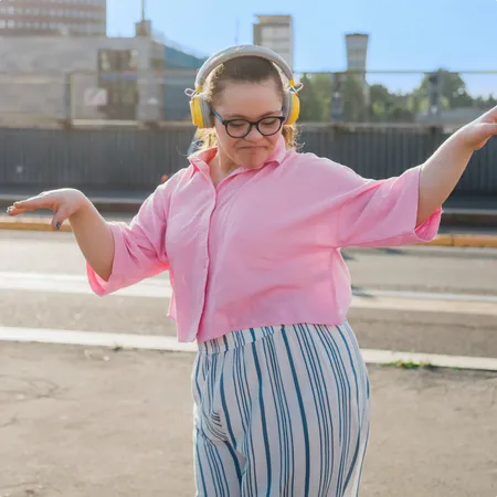 photo of girl with headphones dancing