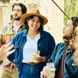 photo of smiling friends sharing drinks 