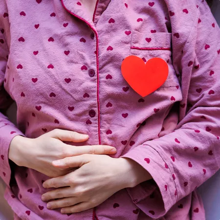 photo of person in pajamas is lying in bed 