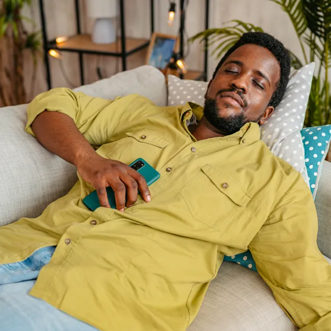 photo of man falling asleep while using phone