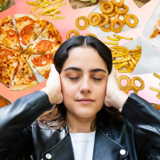 photo of woman covering her ears