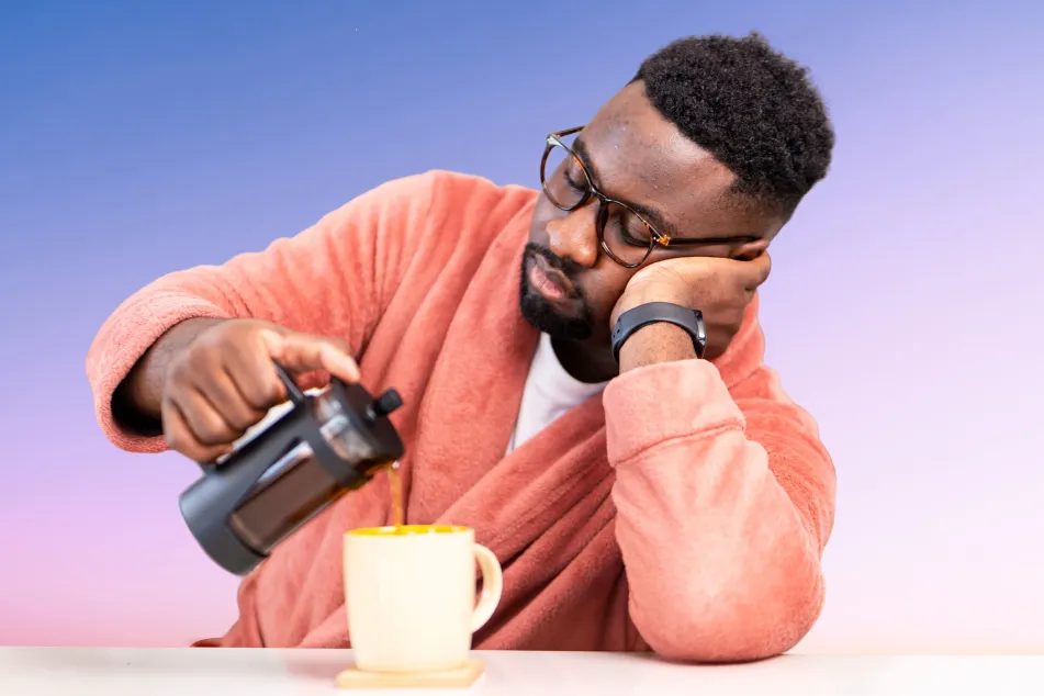 photo of man pouring coffee into a mug