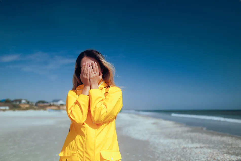 photo of woman covering her face