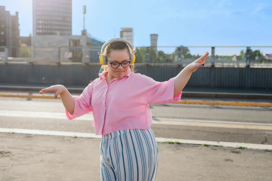 photo of girl with headphones dancing