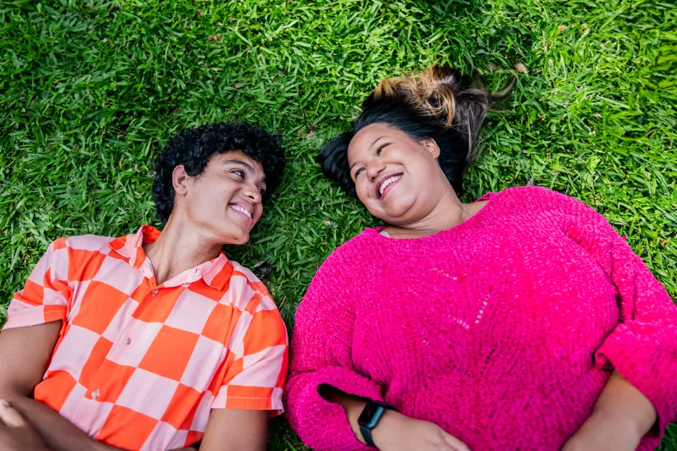 photo of Friends talking lying on grass 