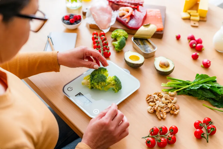 photo of woman weighing food on scale