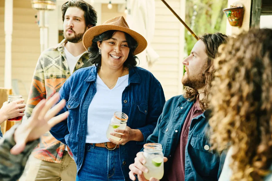 photo of smiling friends sharing drinks 