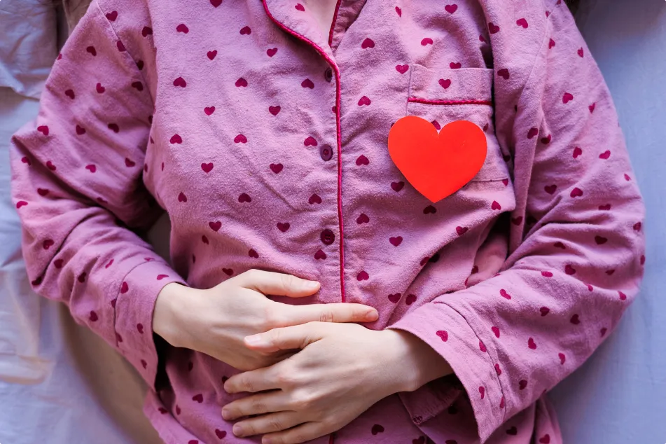 photo of person in pajamas is lying in bed 