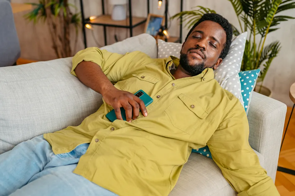 photo of man falling asleep while using phone