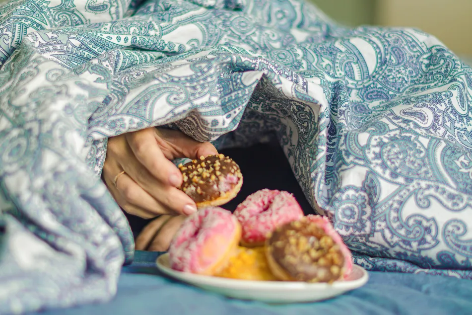 photo of woman reaching hand for tasty bun