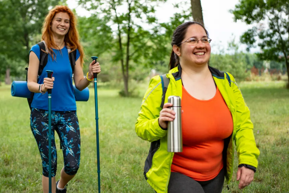 photo of young female friends hiking 