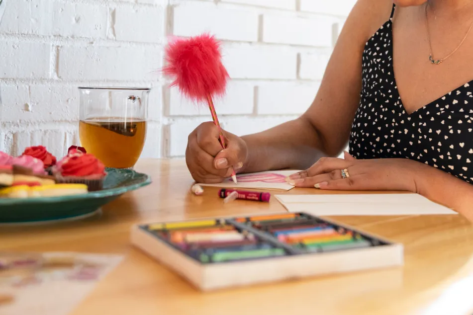 photo of young woman writing note to send
