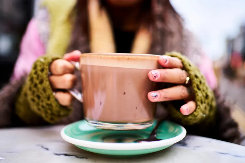 photo of hands holding a cup of hot chocolate 