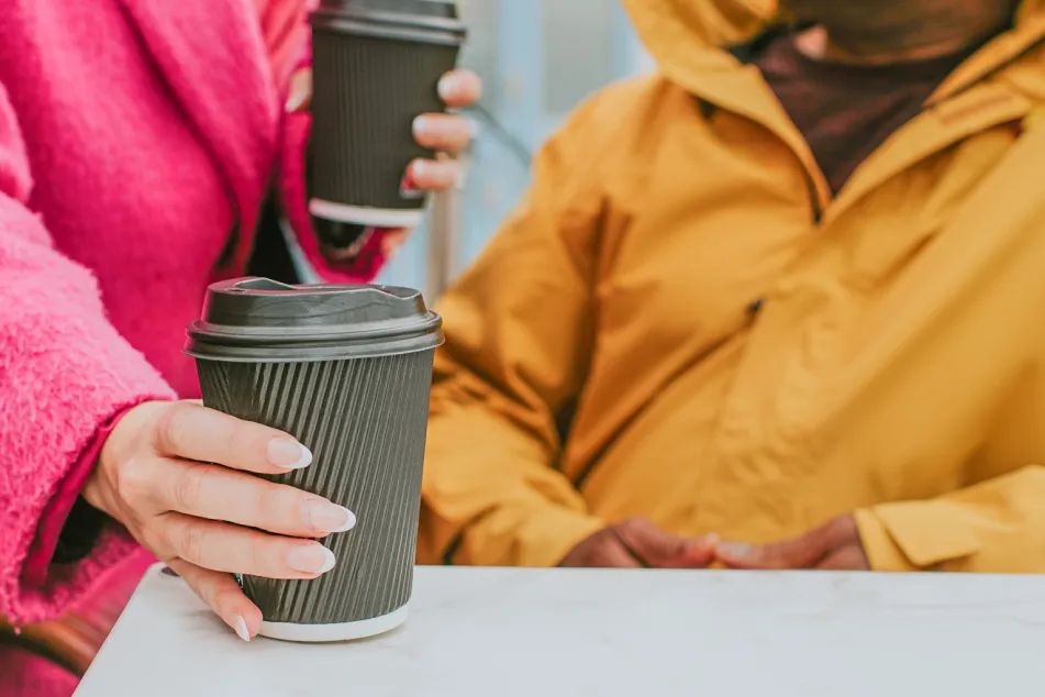 photo of giving stranger a cup of coffee