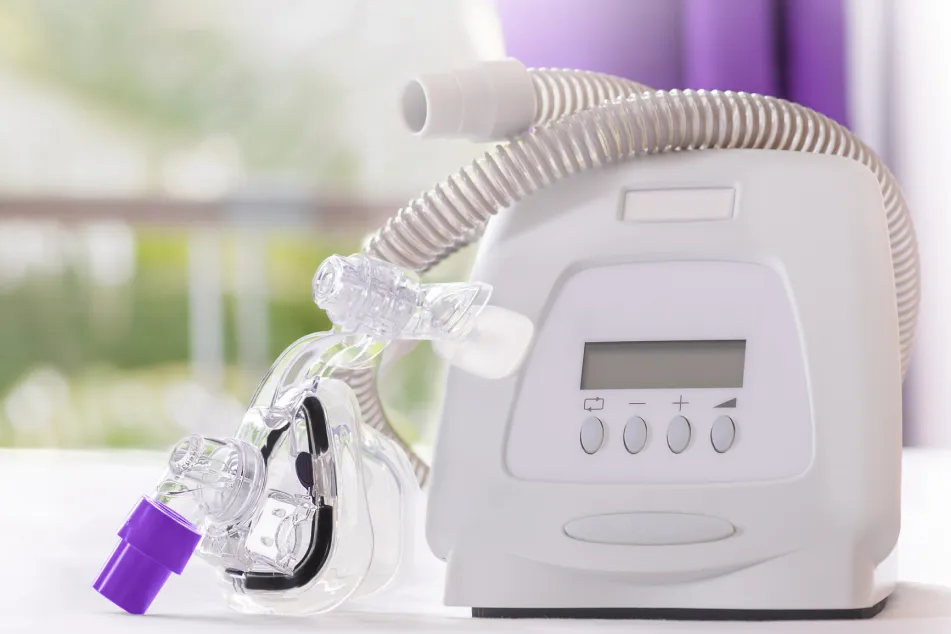 photo of CPAP machine with mask and hose
