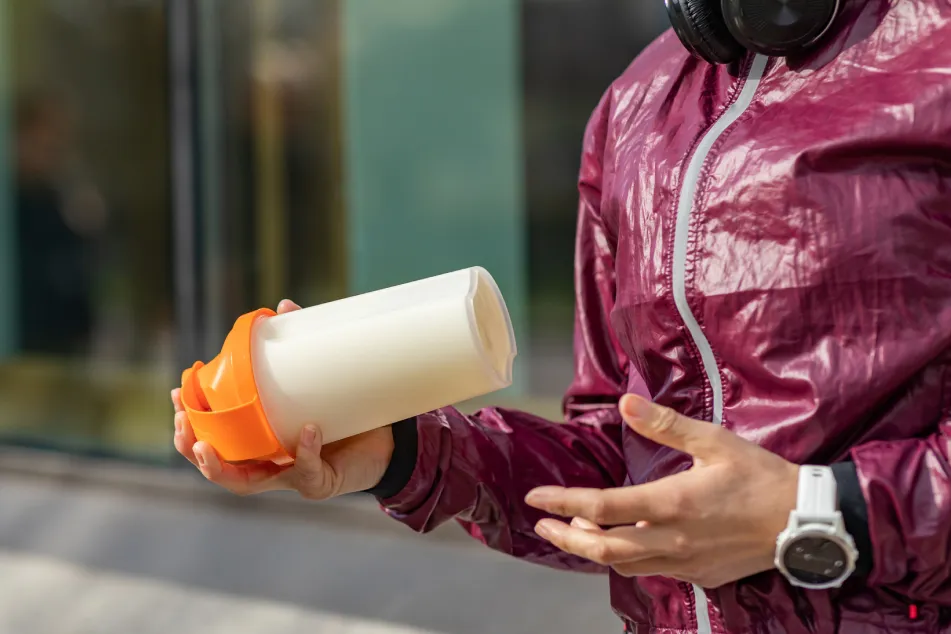 photo of woman shaking a protein drink
